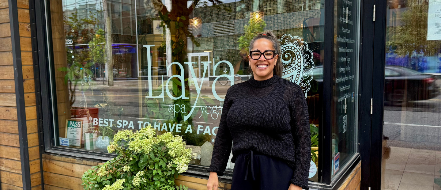 Alessandra de Oliveira standing outside Laya Spa & Yoga celebrating 13 years in West Queen West