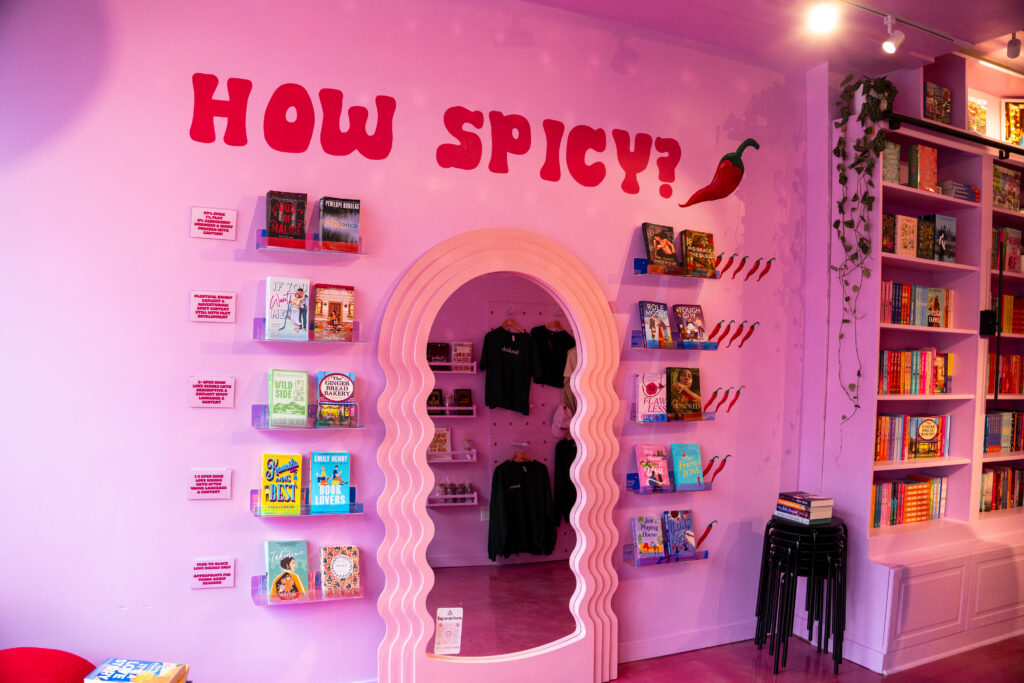 Interior of Hopeless Romantic Books featuring the pink “How Spicy?” wall and the signature romance Spice Meter display.